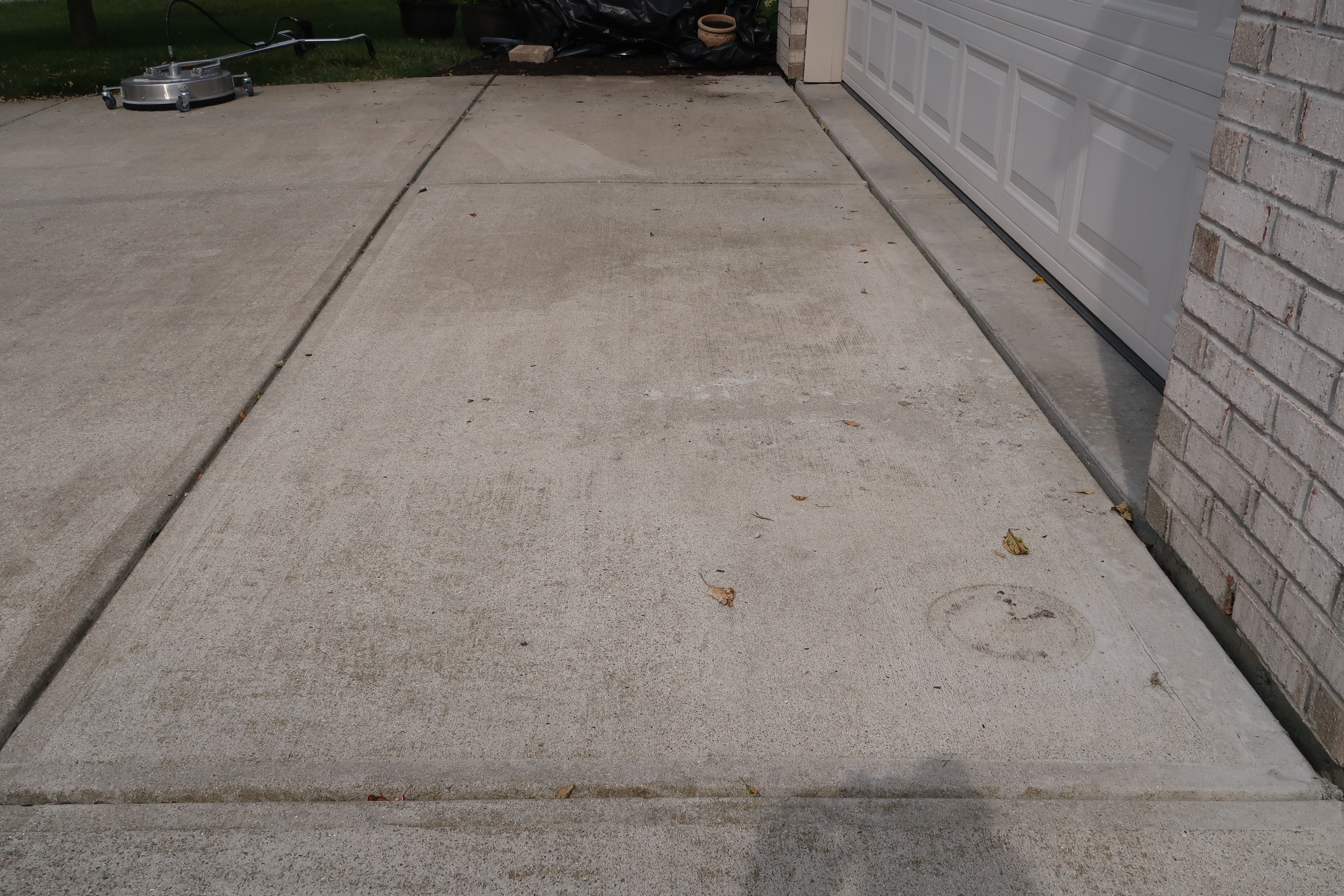 Dirty concrete driveway before cleaning