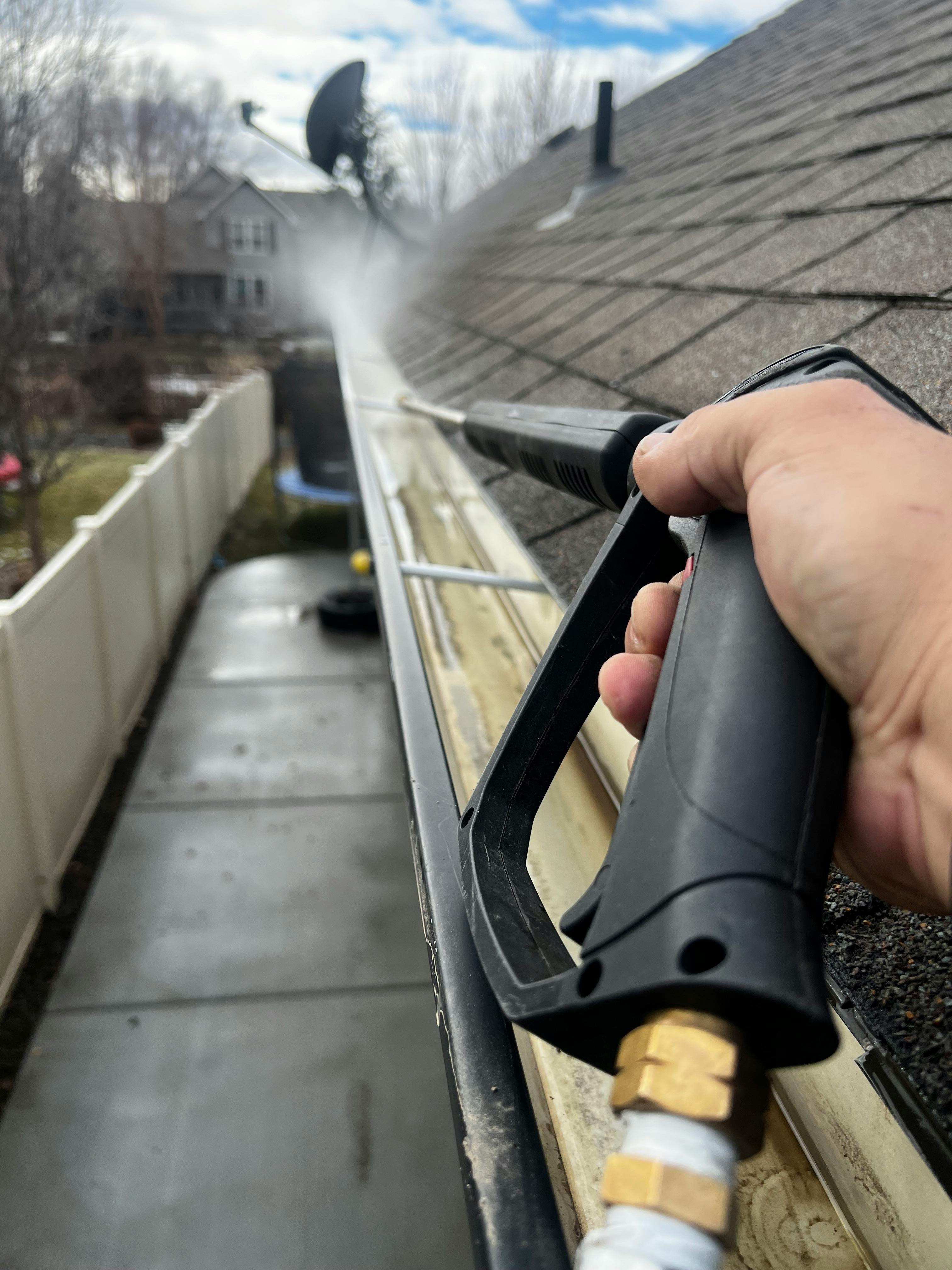 Pressure washing gutters clean with wand attachment