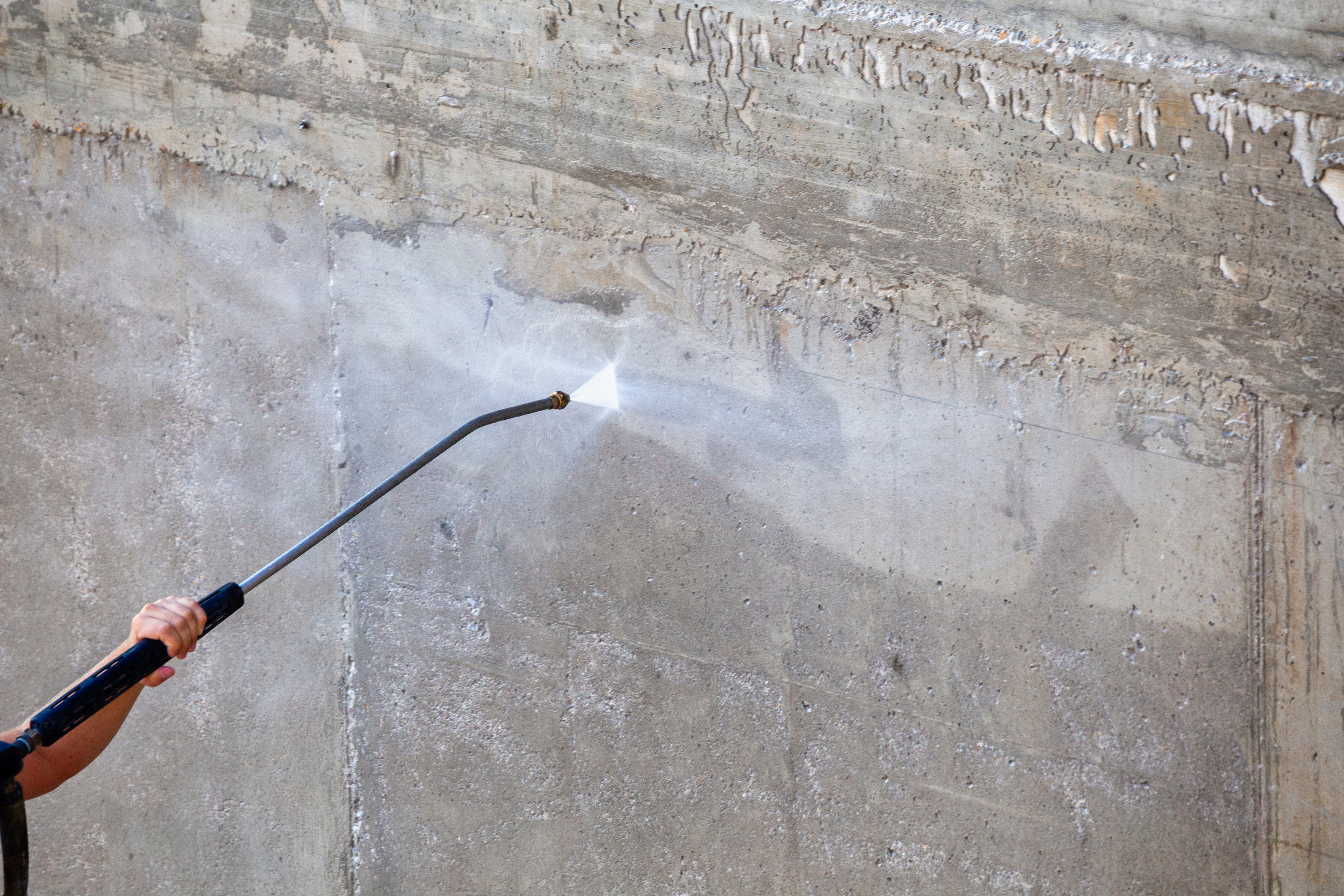 High pressure washing concrete wall