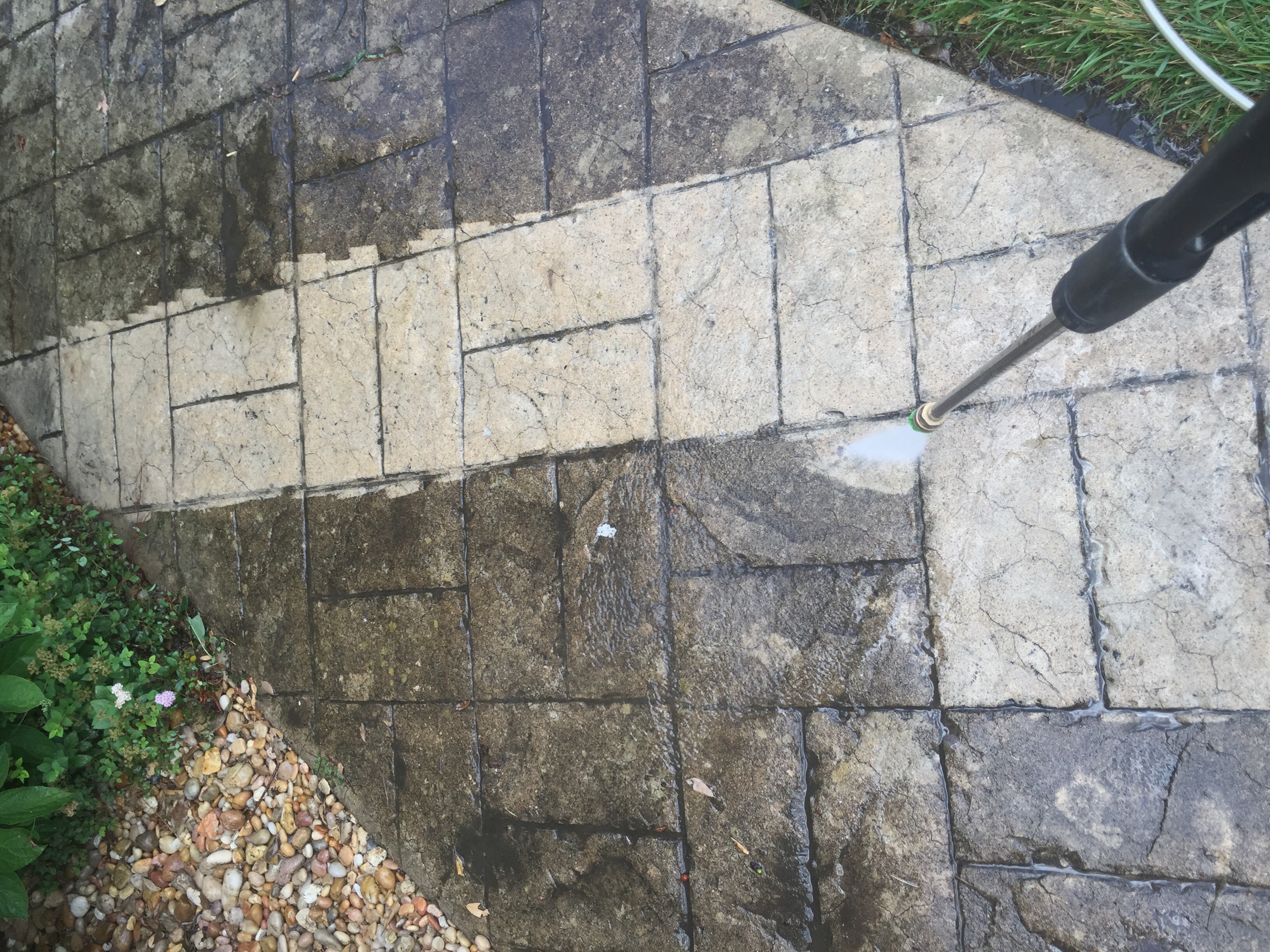 Brick paver patio being pressure washed