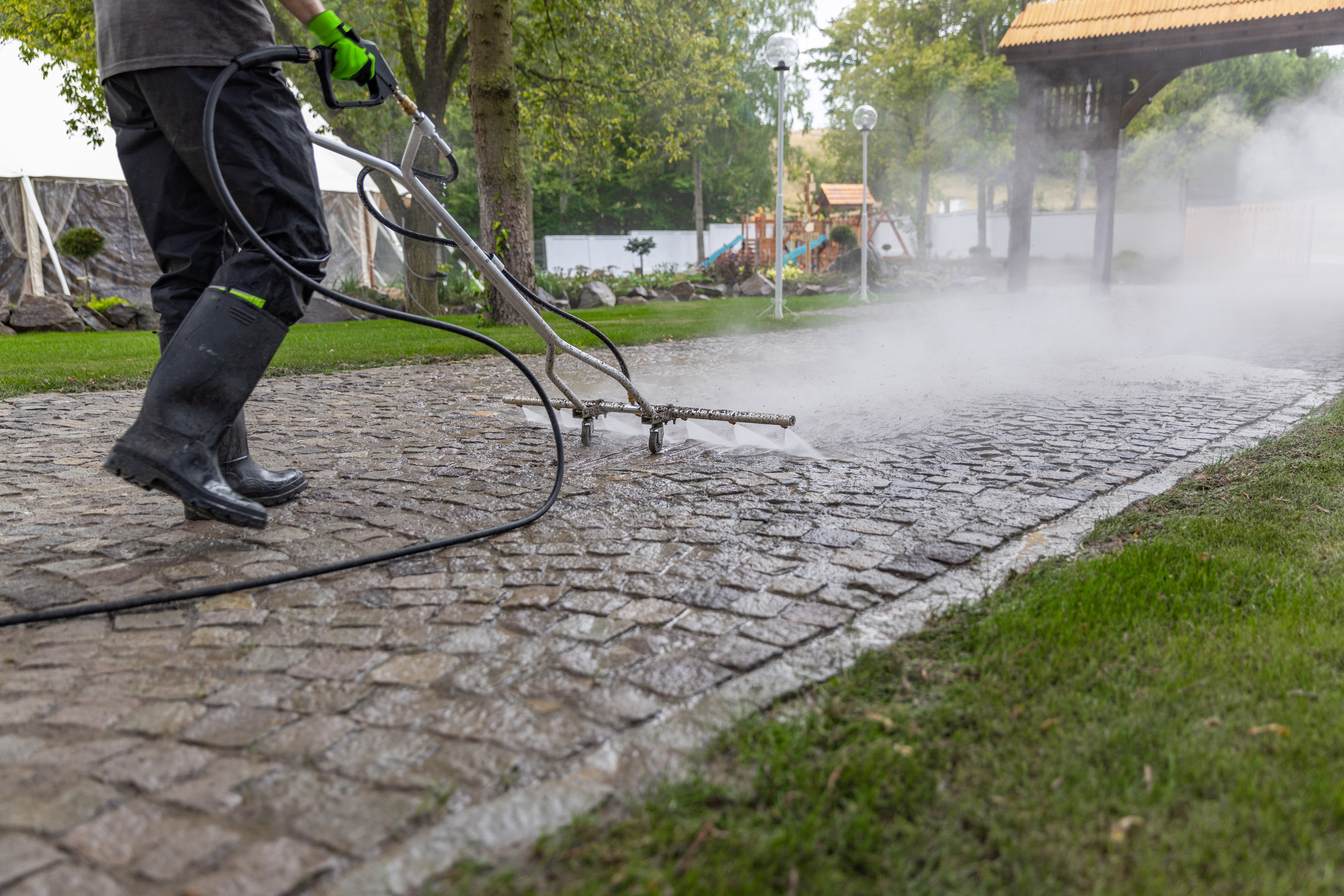 Pressure washing cobblestone driveway